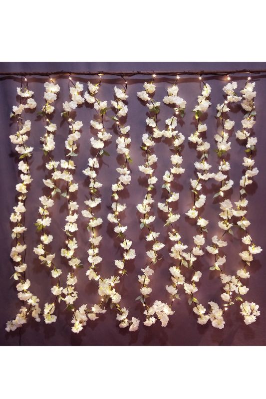 Light pink cherry blossom curtain with 180 warm white LEDs, creating a serene ambiance for any room or event.