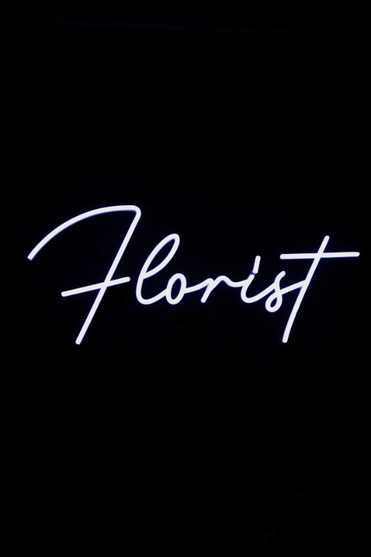Neon LED sign reading 'FLORIST' in elegant white, designed for visibility and style in floral businesses.
