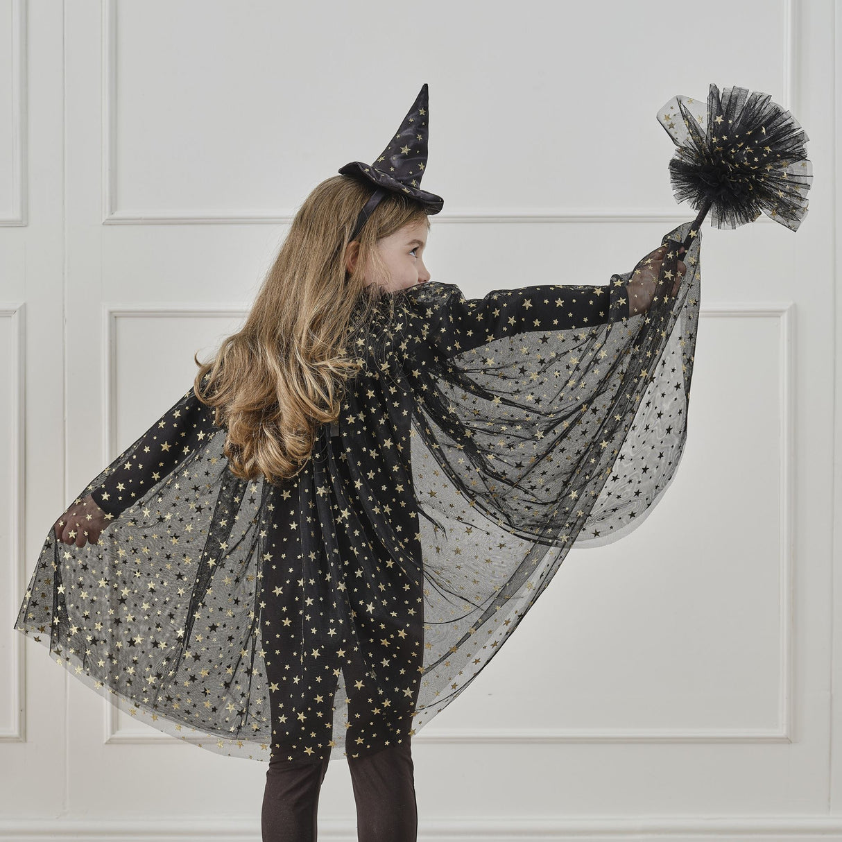 Elegant black witches broom adorned with shimmering gold stars, perfect for Halloween costumes and imaginative play.