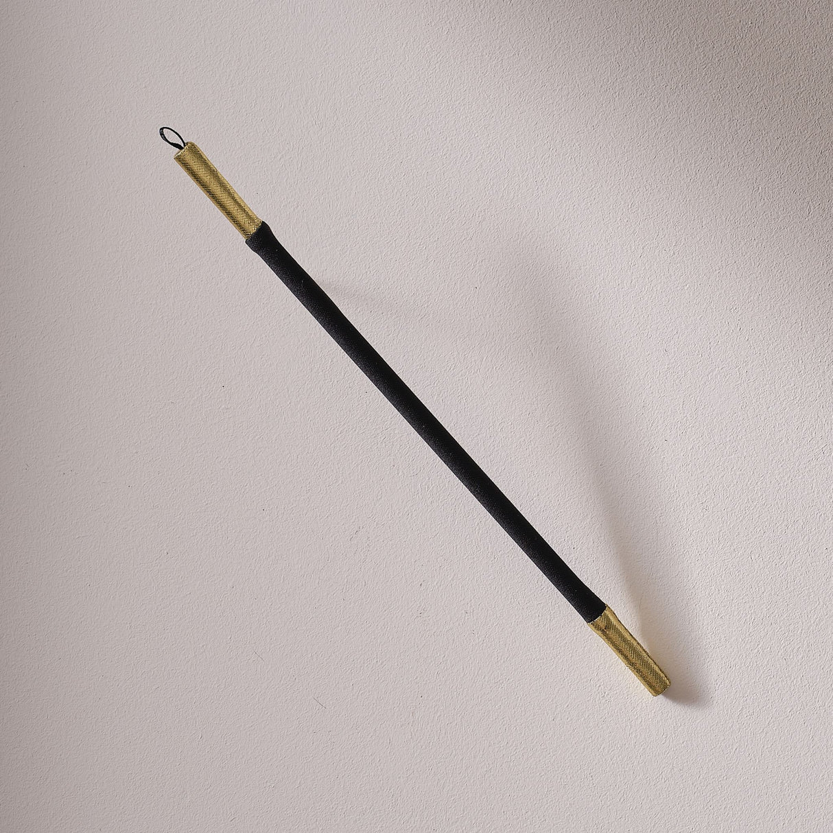 Black velvet magician's wand with elegant gold accents, perfect for fancy dress, performances, and imaginative play.