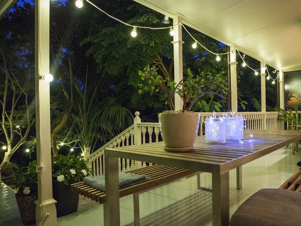 Festoon Party Lights 10M with 14 glass bulbs on white wire, perfect for indoor and outdoor gatherings, creating a warm glow.