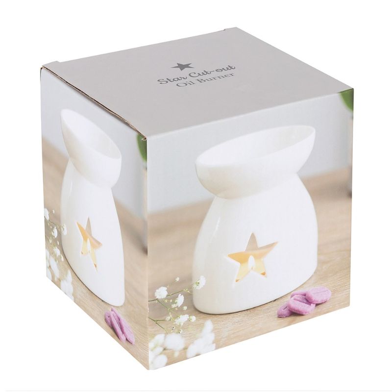 Elegant white ceramic oil burner with star cutouts, perfect for creating a cozy ambiance and compatible with various fragrances.