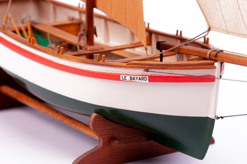 Detailed model ship kit of the 1850 Le Bayard fishing vessel, featuring unvarnished wooden hull components for crafting.