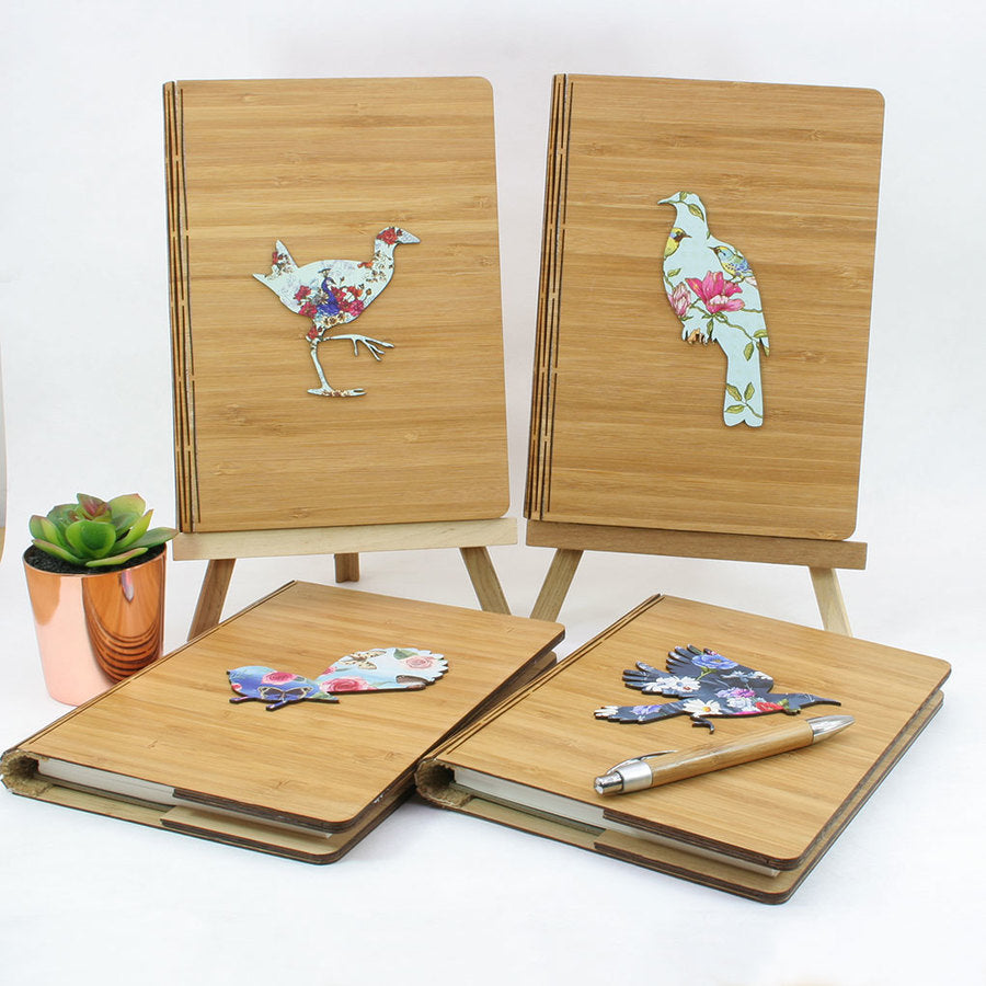 Eco-friendly bamboo journal featuring a floral pukeko design, perfect for jotting down thoughts and sketches. A5 size.