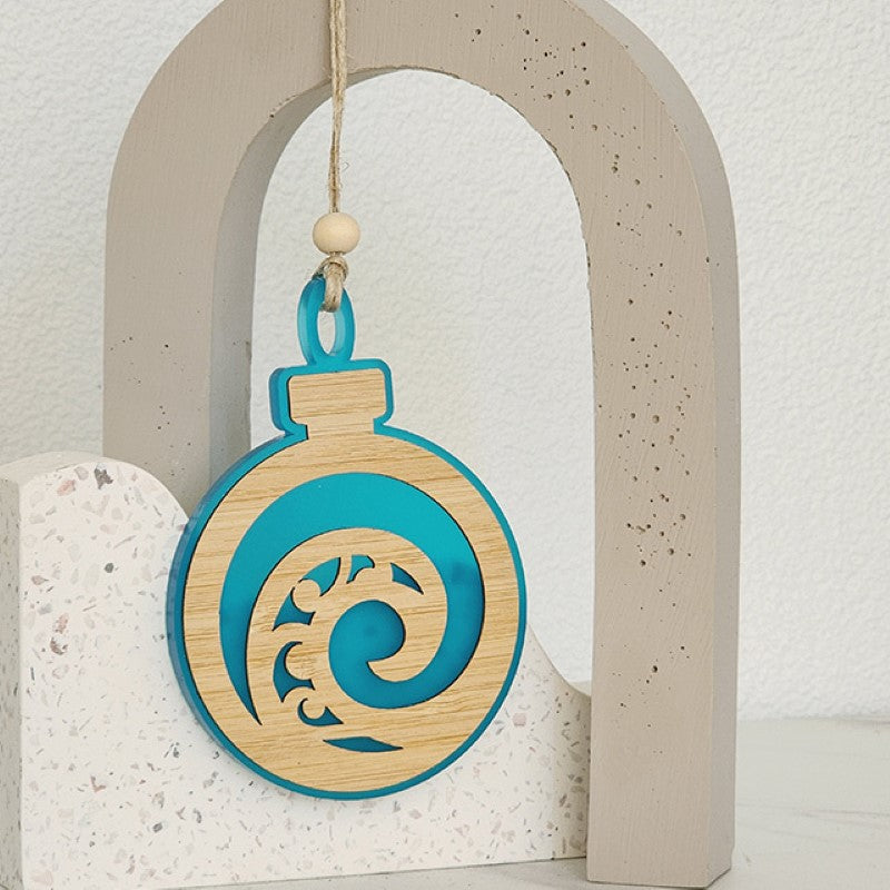 Teal acrylic Koru bauble ornament, elegantly designed for home decor, ready to hang and perfect for gifting.