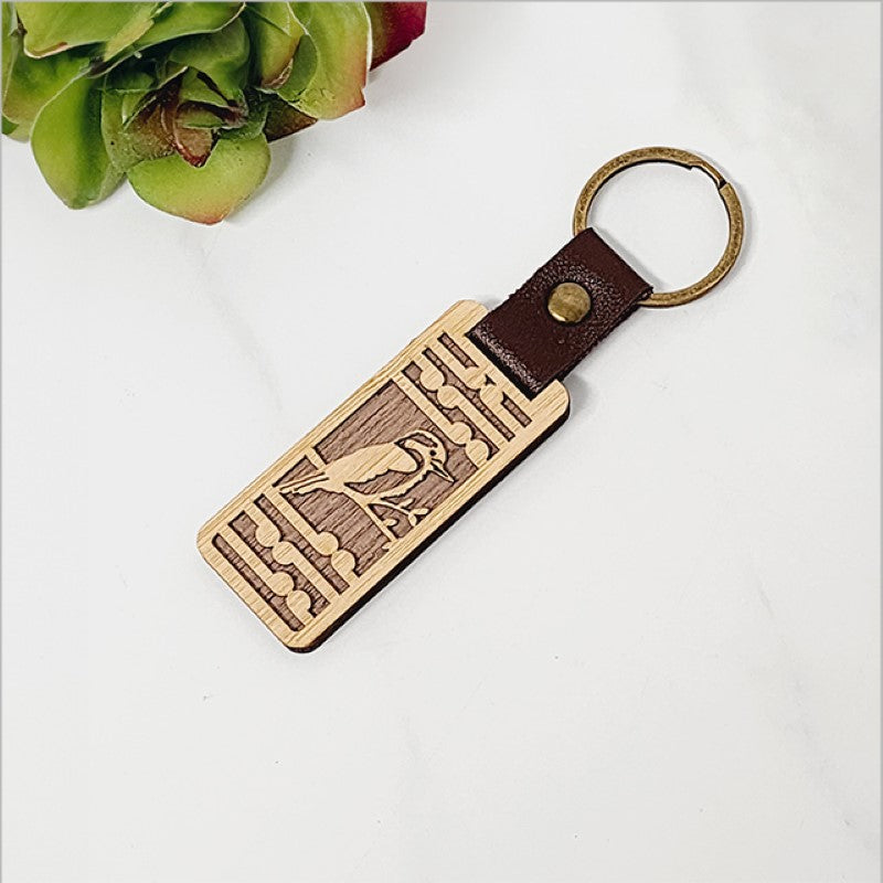 Bamboo keyring featuring a Kingfisher design and Koru pattern, perfect for adding Kiwiana charm to your keys.