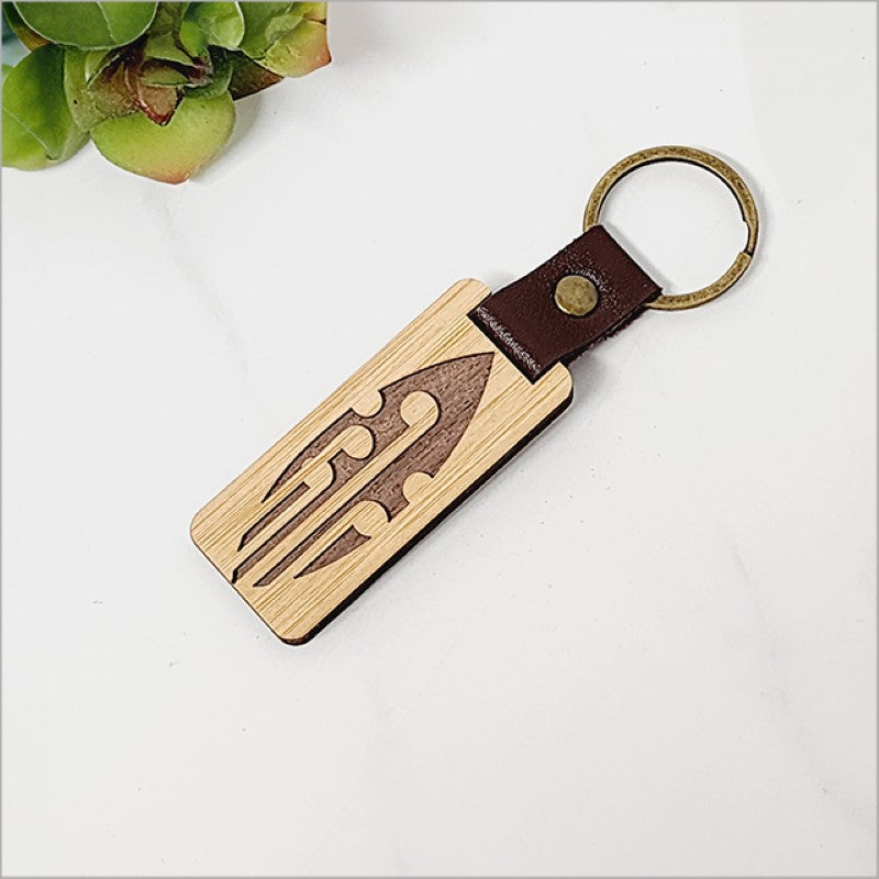 Eco-friendly bamboo keyring with Kiwiana design, lightweight and stylish, perfect for keys or as a unique gift.
