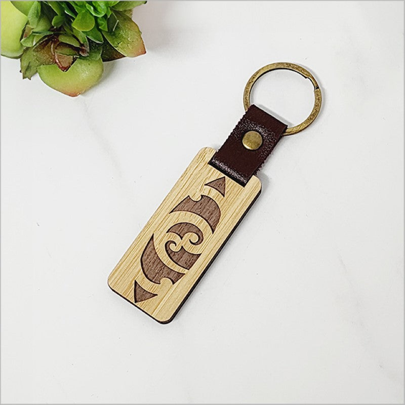 Laser-cut bamboo keyring with Kiwiana charm, eco-friendly and lightweight, perfect for stylish key organization.