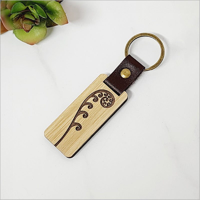 Eco-friendly bamboo keyring featuring a detailed frond design, perfect for stylish organization and Kiwiana gifts.