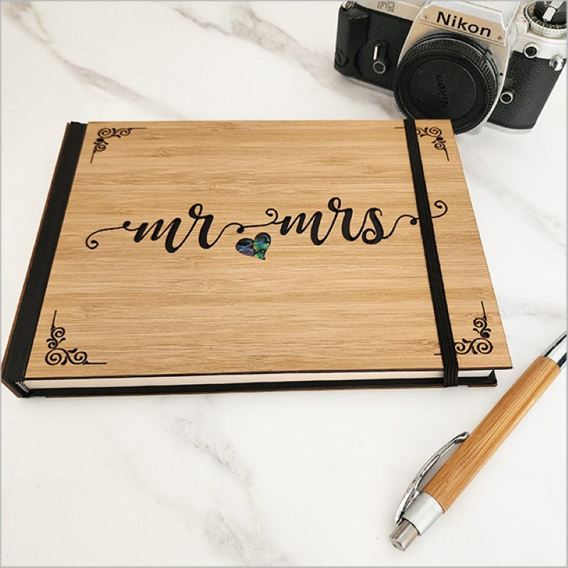 Elegant Mr & Mrs guest book in laser-cut bamboo with NZ Paua, featuring 128 acid-free pages for memories and signatures.