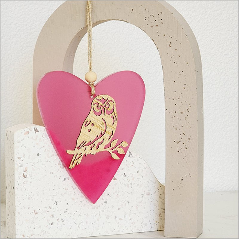 Pink satin heart ornament featuring intricate laser-cut bamboo design, perfect for home decor or gifting.