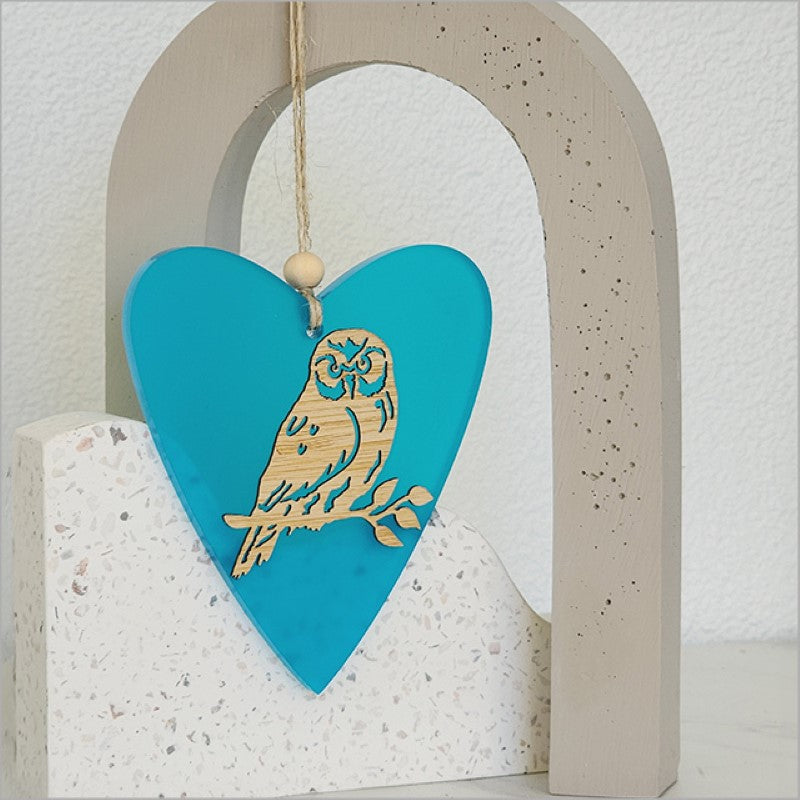 Teal satin acrylic heart ornament with laser-cut bamboo design, perfect for home decor or gift-giving.