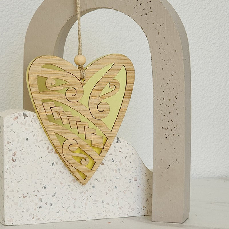 Heart-shaped hanging ornament in vibrant yellow satin acrylic, crafted from laser-cut bamboo, perfect for decor or gifting.