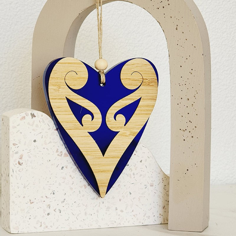 Elegant blue satin acrylic heart ornament with Koru patterns, perfect for decorating or gifting. Dimensions: 90mm x 105mm x 8mm.