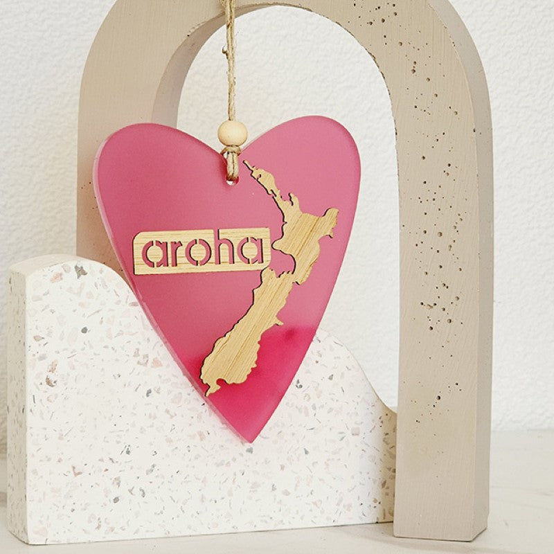Heart-shaped pink satin acrylic hanging ornament with laser-cut bamboo base, perfect for home decor and gifts.