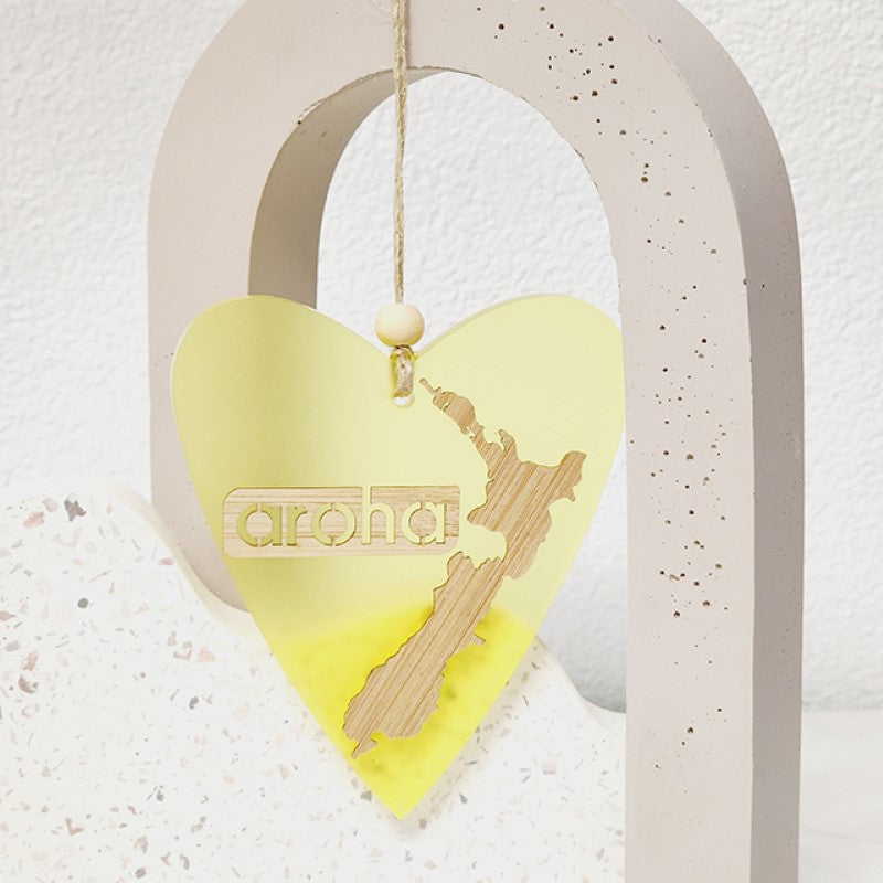 Heart-shaped hanging ornament in yellow satin acrylic, crafted from bamboo, perfect for home decor or gifting.