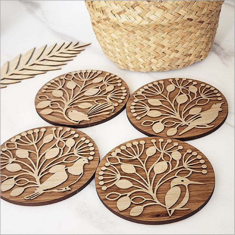 Bamboo and Rimu coasters set featuring Pohutukawa circles and NZ native birds, elegantly packaged in a gift box.