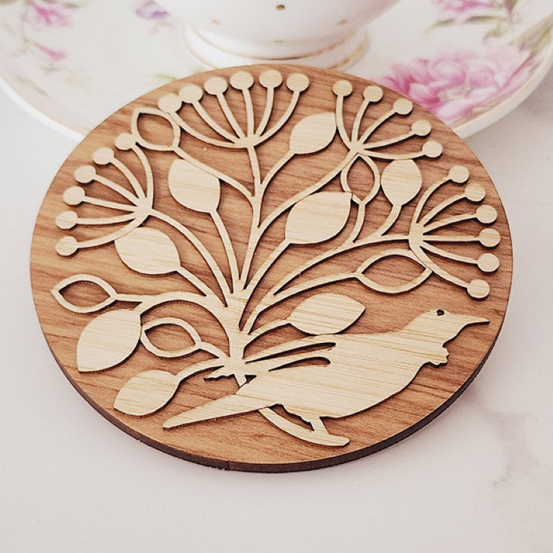 Bamboo and Rimu coasters featuring Pohutukawa circles and NZ native birds, beautifully packaged as a thoughtful gift.