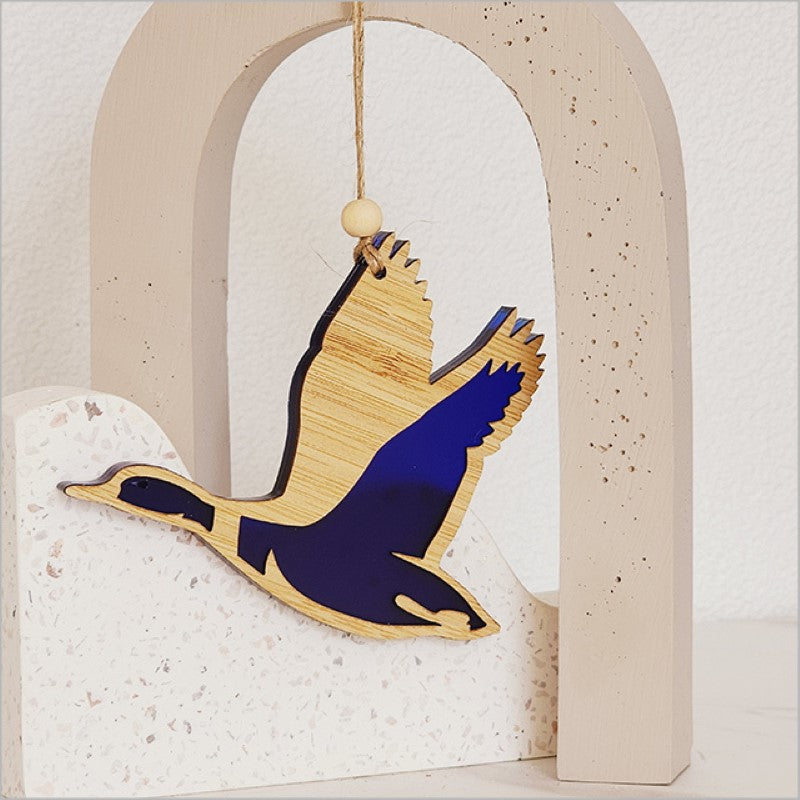 Hanging acrylic duck ornament in blue satin finish, perfect for home decor or as a unique gift.