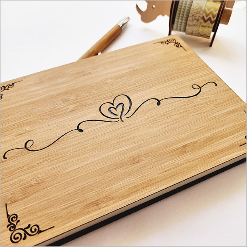 Elegant small guest book with laser cut bamboo design, ideal for preserving memories and creative expression.