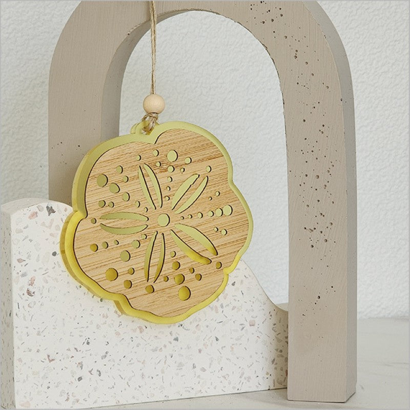 Laser-cut acrylic and bamboo hanging ornament in vibrant yellow, perfect for home decor and thoughtful gifts.