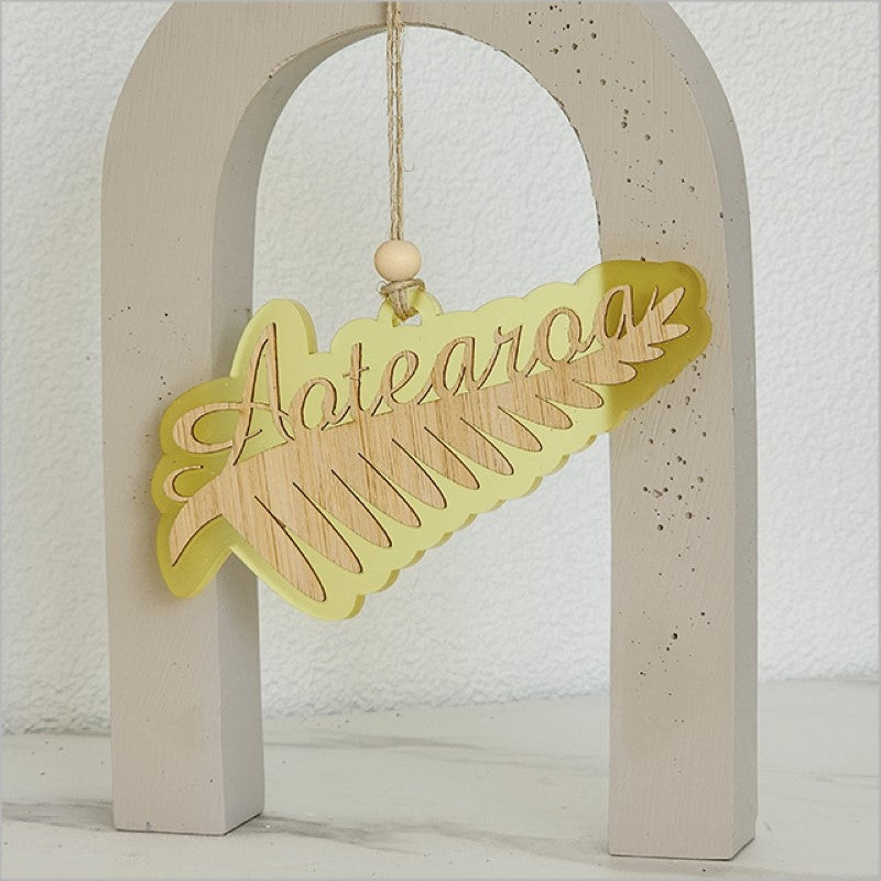 Acrylic Silver Fern ornament in yellow satin, showcasing New Zealand culture; perfect for home decor or gift giving.