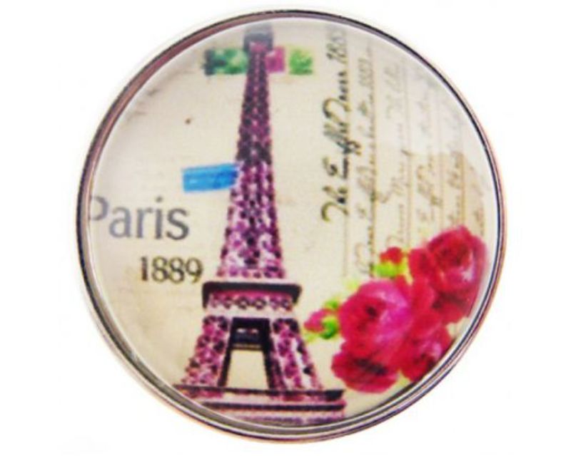 Vibrant Eiffel Tower sculpture adorned with red flowers, capturing the romance of Parisian decor.