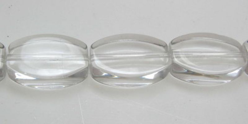 Set of 32 clear 11mm flat oval glass beads, perfect for elegant DIY jewelry and craft projects.