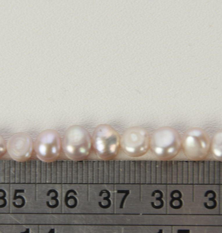 Freshwater pearls in elegant purple, set of 4; ideal for stunning jewelry designs and unique accessories.