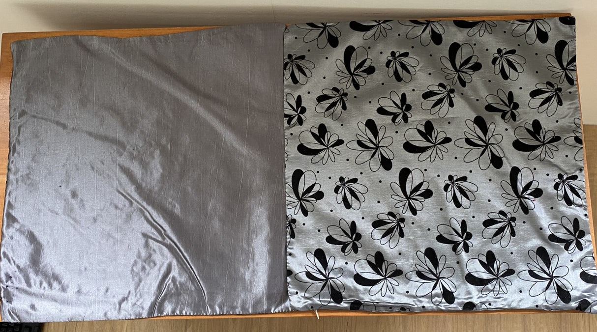 Set of 6 silver cushion covers featuring a black floral design, crafted from soft satinee fabric with a zip closure.