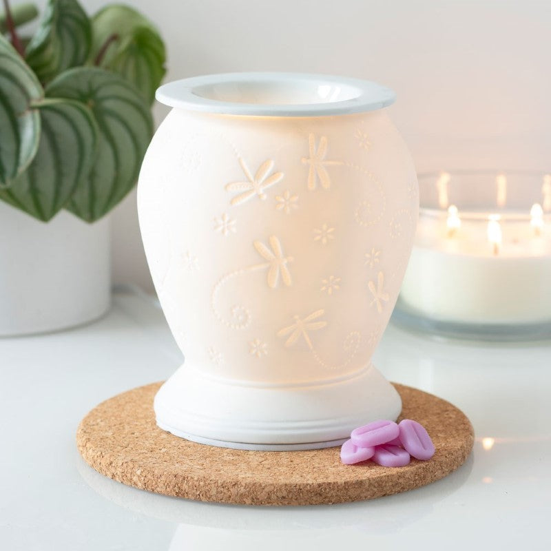 Dragonfly White Ceramic Electric Oil Burner with warm yellow glow, perfect for diffusing fragrances and enhancing home decor.