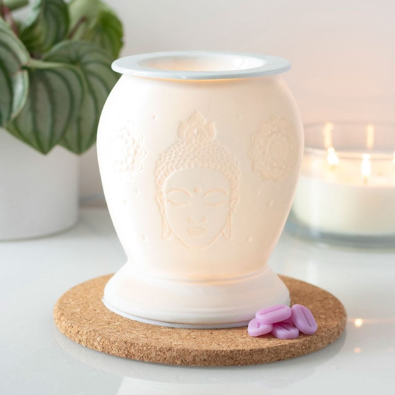 Buddha White Ceramic Electric Oil Burner with soft yellow glow, perfect for aromatherapy and home decor.