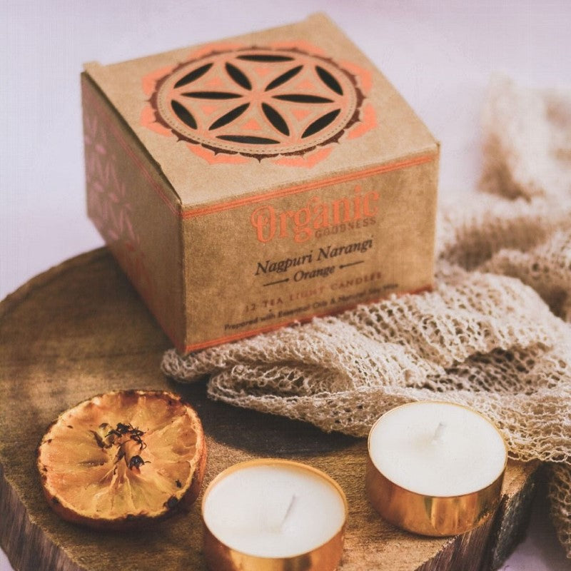 Set of 12 organic orange tealight candles in a kraft box, hand-poured soy wax, invigorating citrus scent, eco-friendly.