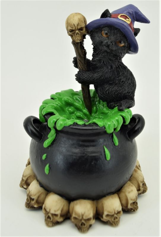 Black cat peering from a cauldron, illuminated by warm LED lights; perfect Halloween decor or gift for cat lovers.