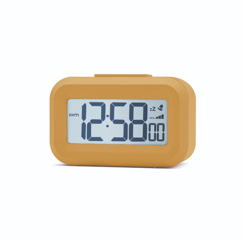 Mustard yellow LCD alarm clock with white backlight, snooze, and volume control, compact size for bedside use.