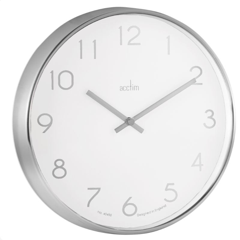 Modern chrome wall clock with white face, debossed numerals, and clear glass lens, perfect for any home or office decor.