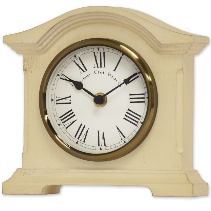 Distressed cream mantel clock with antique brass bezel and Roman dial, combining vintage charm and precise quartz movement.