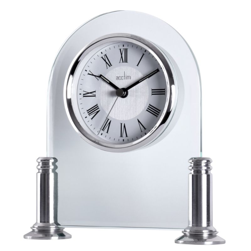 Silver mantel clock with glass arch, polished pillars, and luminous hands; energy-efficient design for stylish timekeeping.