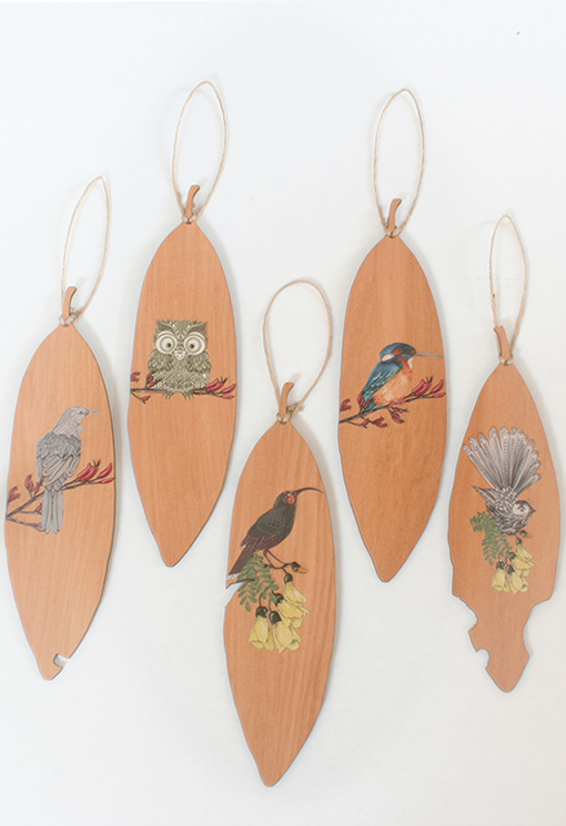 Wall art featuring a Morepork owl and Pohutukawa leaf printed on Rimu veneer, perfect for nature-inspired decor.