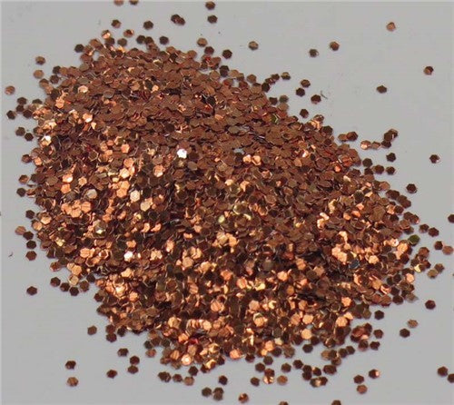 Fine copper glitter in a 10gm package, perfect for adding shimmer to scrapbooking and DIY projects.