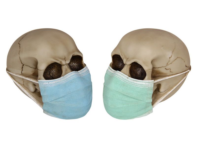 Set of 2 skull ornaments with surgical face masks, 15cm tall, perfect for edgy decor and themed events.