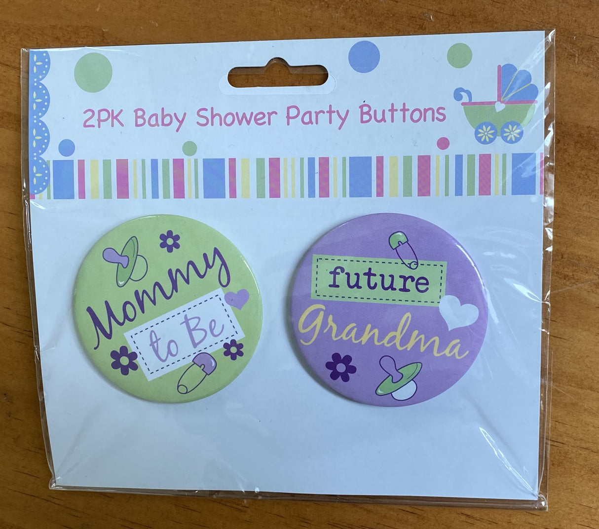 Adorable 2-pack baby shower buttons featuring cheerful designs, perfect as keepsakes and low-cost party favors.