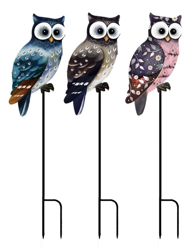 Colorful set of 12 metal owl garden stakes, 56cm tall, adding whimsical charm to outdoor spaces.
