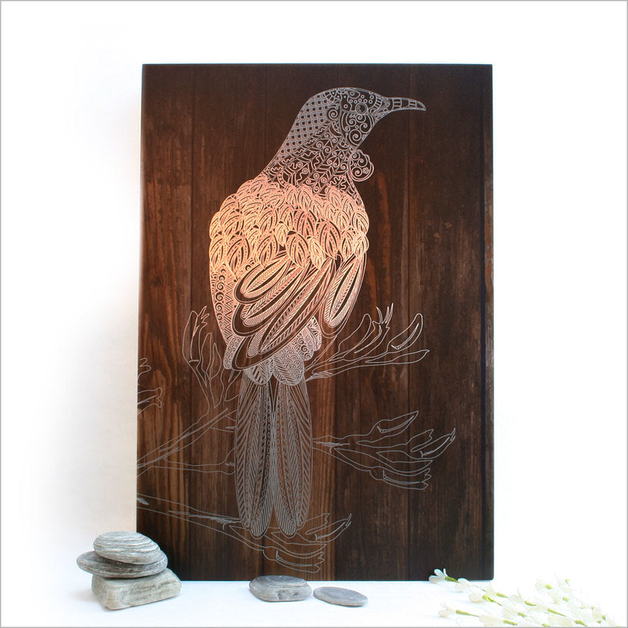 Elegant wall art featuring a Tui bird printed on dark wood, ideal for home or covered outdoor spaces, 28.8cm in size.