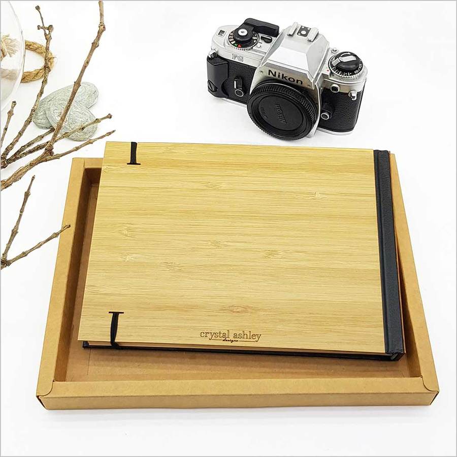 Large hardbound guest book with laser-cut bamboo, paua accents, and 128 acid-free pages, perfect for special occasions.