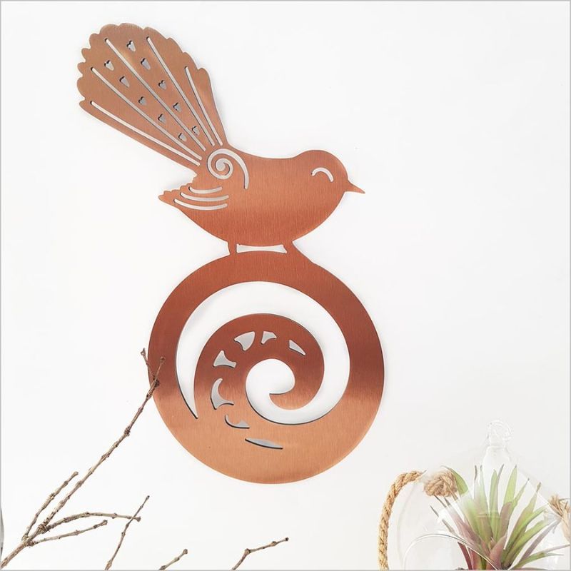 Wall art featuring a Fantail on a Koru, made of brushed copper ACM, 42cm, perfect for indoor or outdoor decoration.