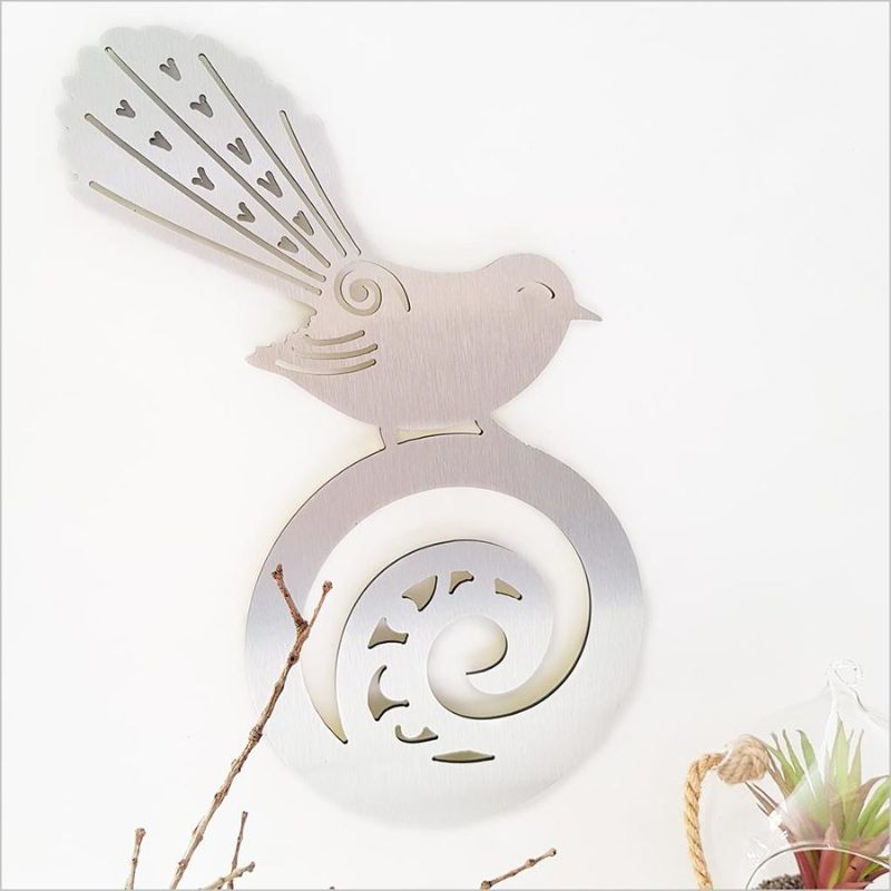 Brushed silver wall art featuring a beautiful fantail on koru, measuring 42 cm, perfect for indoor or outdoor decor.