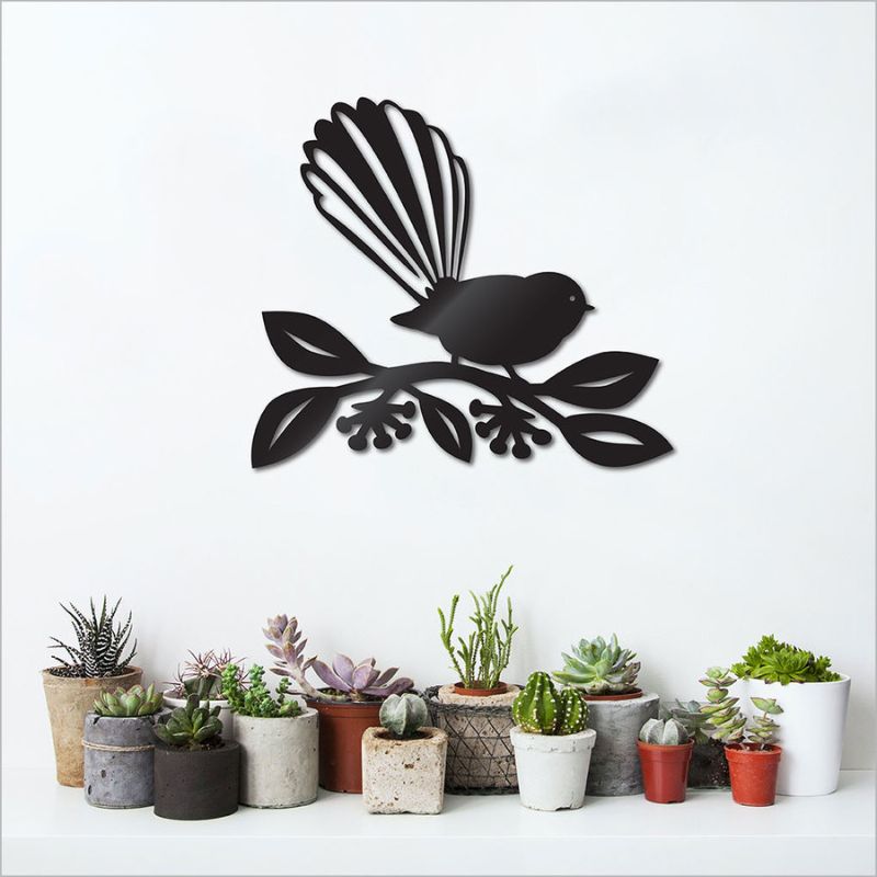 Fantail nestled in vibrant pohutukawa blossoms, crafted from durable black ACM, 75cm wall art for indoor or outdoor elegance.