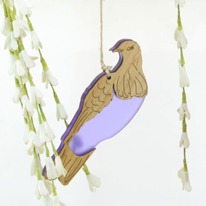 Hanging ornament of New Zealand's Kereru bird, made from bamboo and purple satin acrylic, perfect for home decor or gifting.