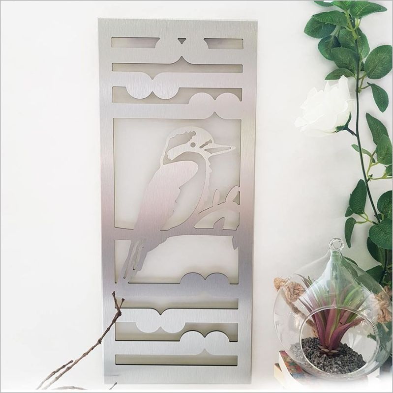 Brushed silver wall art panel featuring intricate Kingfisher and Koru design, perfect for indoor or outdoor decor.